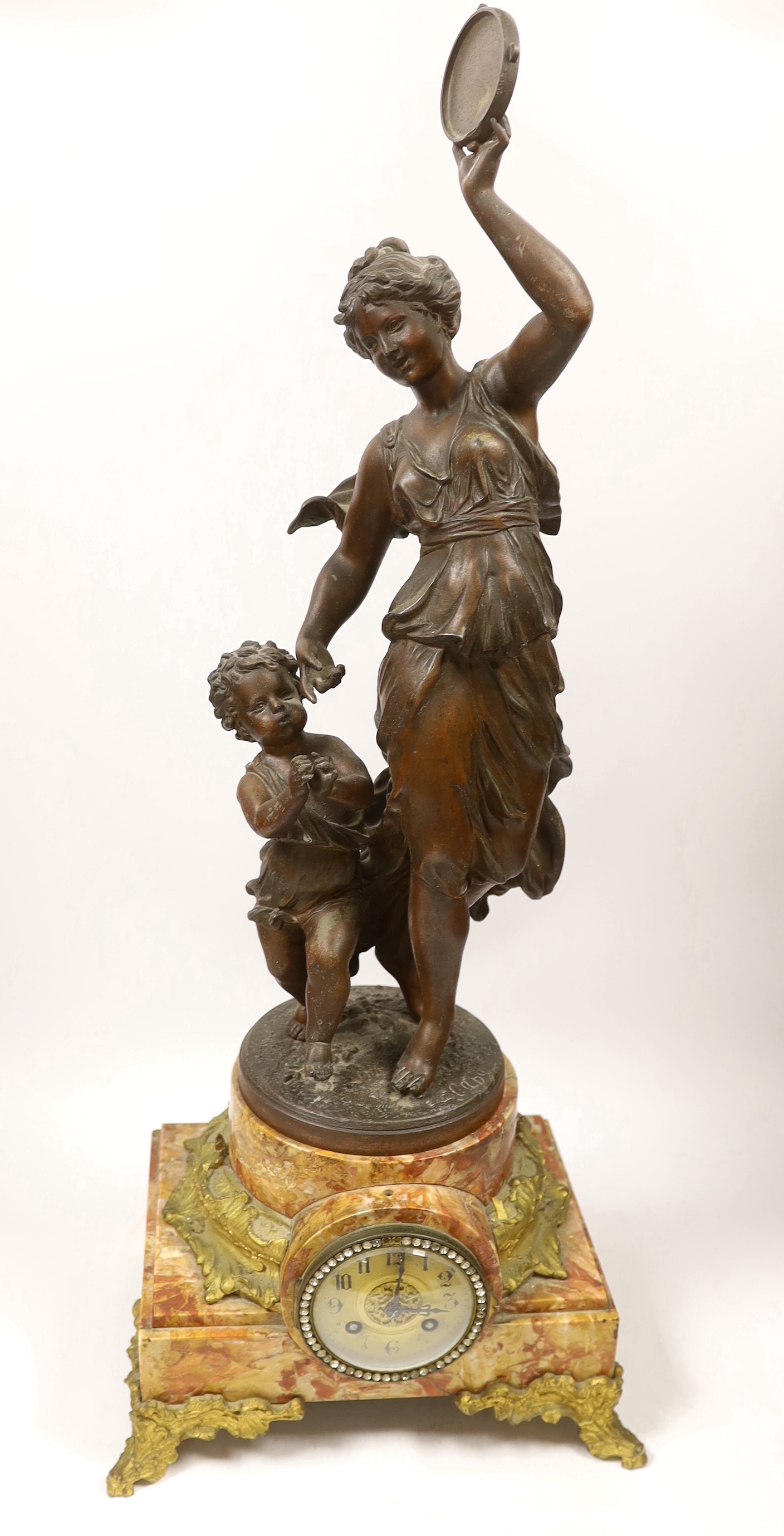 A large bronzed spelter dancer and putti table clock on marble base, 70cm high